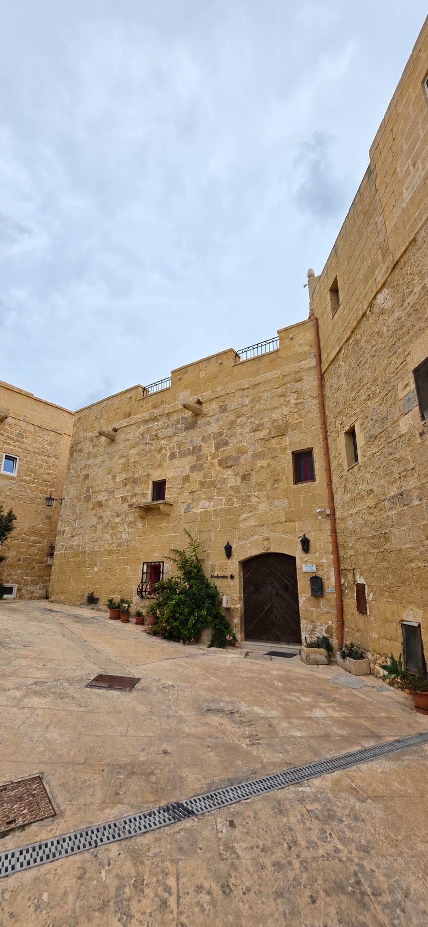 Historic limestone facade and entrance of Molendini Farmhouse