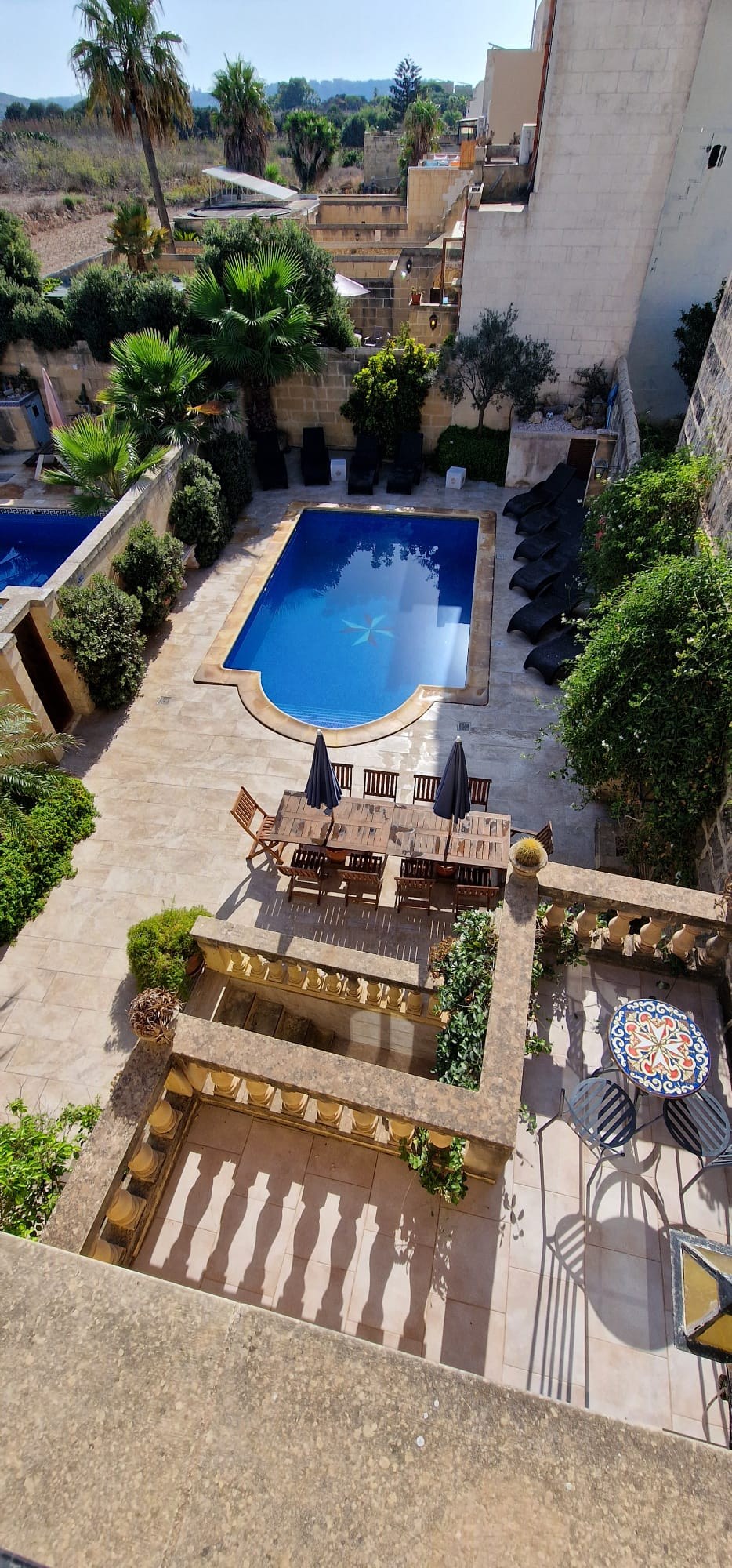 Pool and dining terrace from above at Molendini Farmhouse